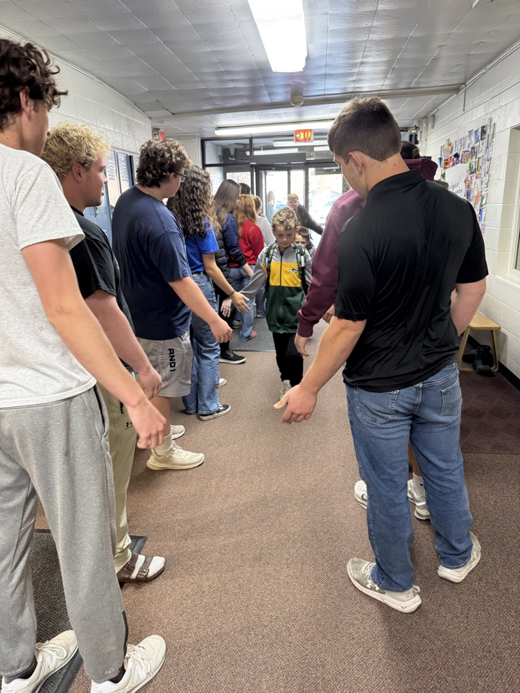 Members of the senior class at the elementary school for High Five Friday giving high fives