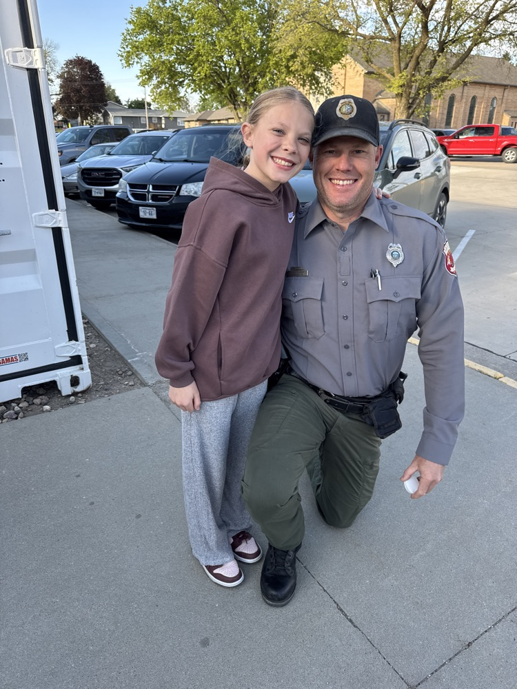 Game Warden Johnson and his daughter posing for a picture 