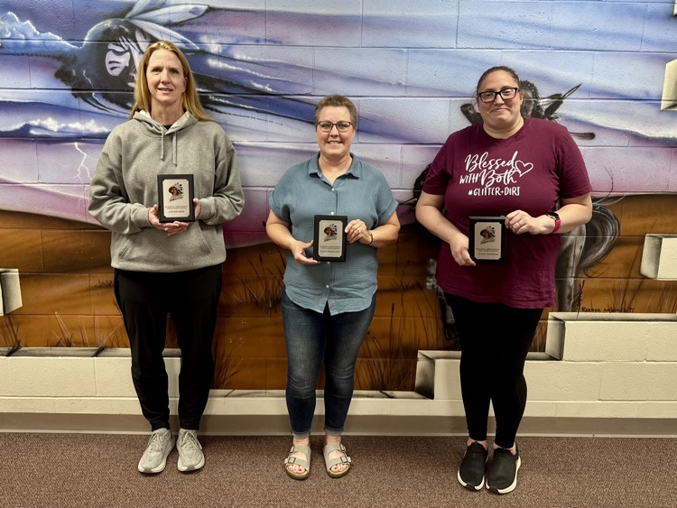 Ann Kramer, Dana Wortmann, Alicia Thunker receiving service awards at the high school 
