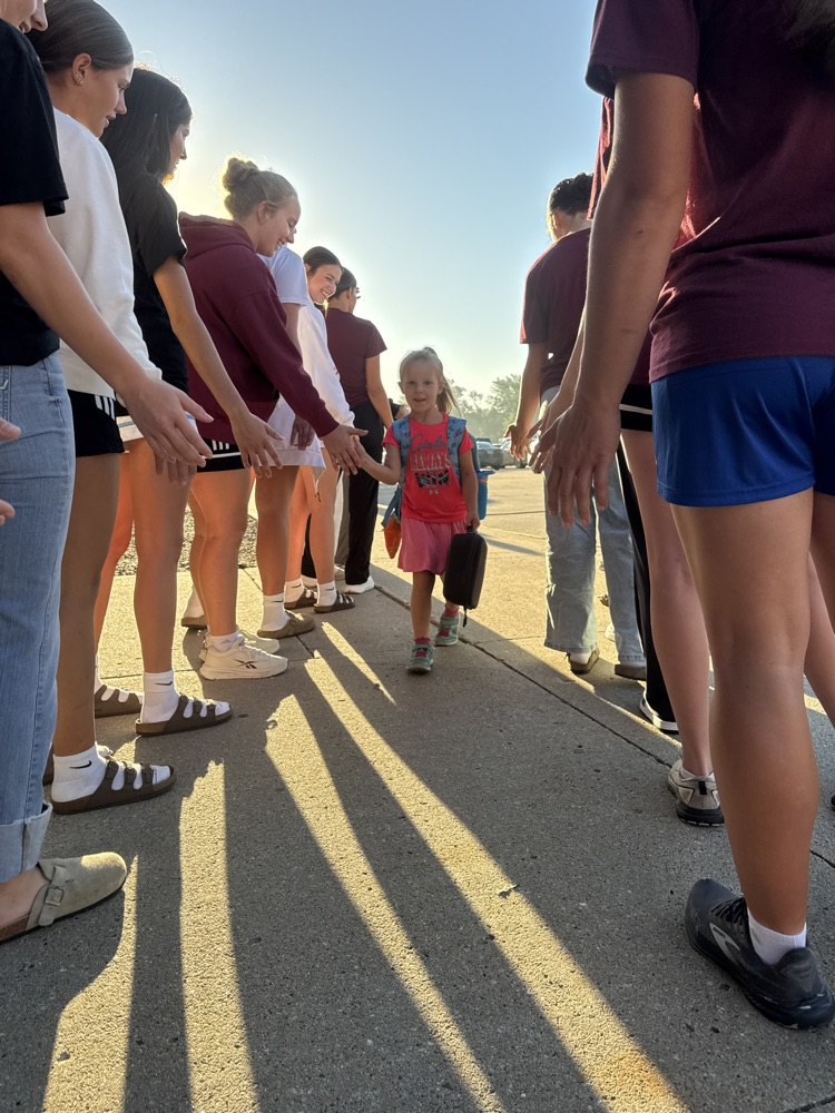 Crofton Volleyball Team handing out high fives and smiles to students 