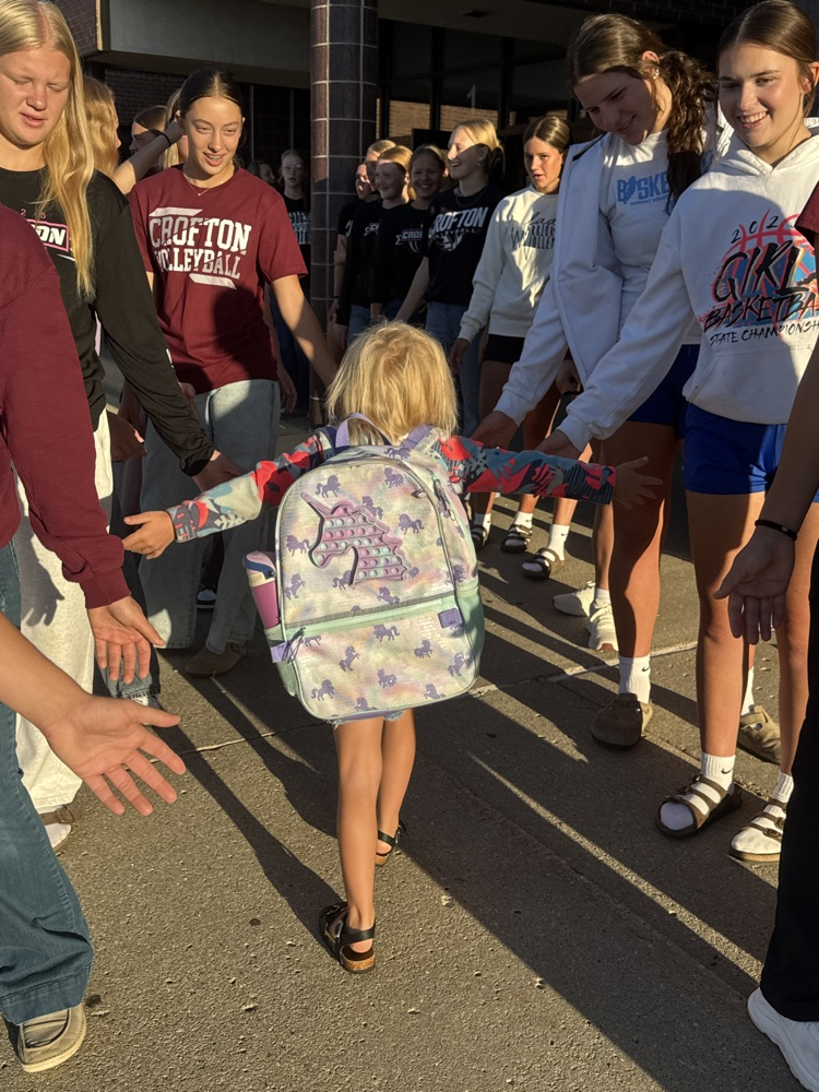 Crofton Volleyball Team handing out high fives and smiles to students