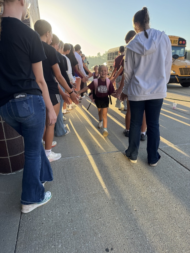 Crofton Volleyball Team handing out high fives and smiles to students
