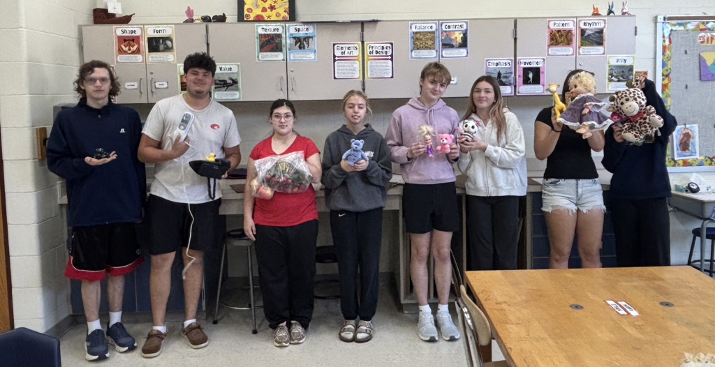 Macklin, Aydin, Frances, Brielle, Dominik, Bella, Shaun, and Becca showing their thrift store finds.