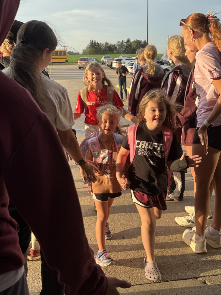 Cross Country team giving high fives to students at High Five Friday 