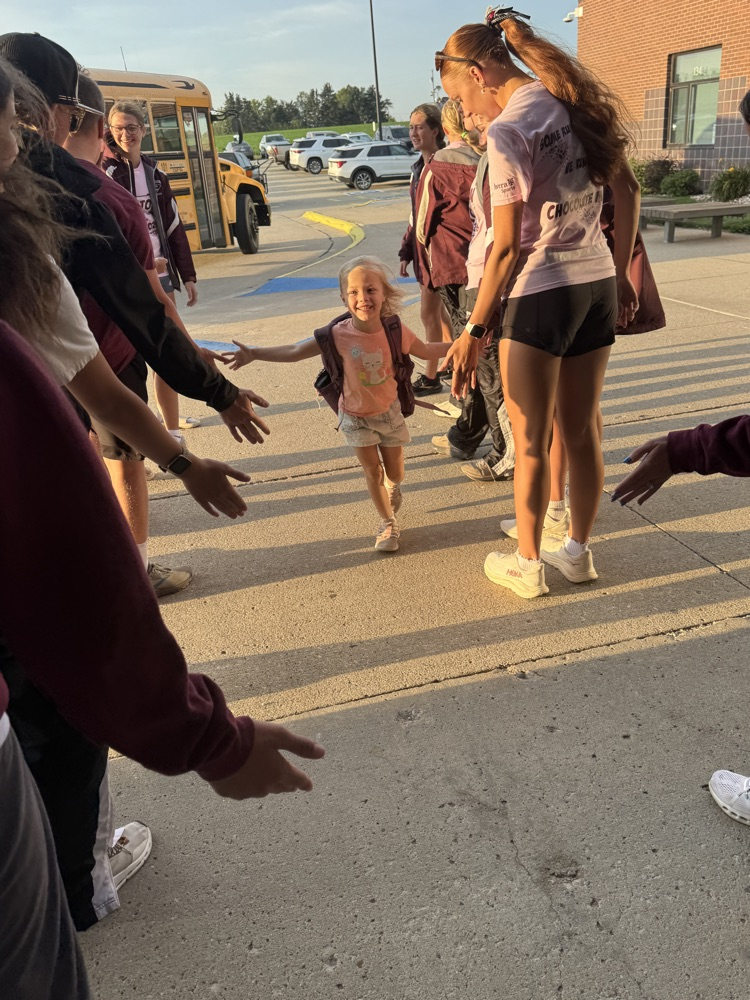 Cross Country team giving high fives to students at High Five Friday 