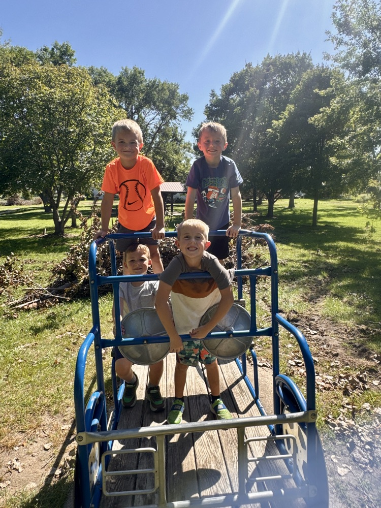The work is done so now the kindergarteners are enjoying recess at the park on the toy pickup truck!