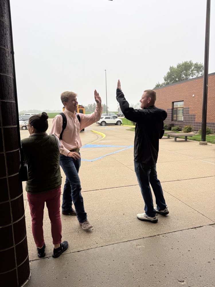 Administrators for High Five Friday standing outside greeting students