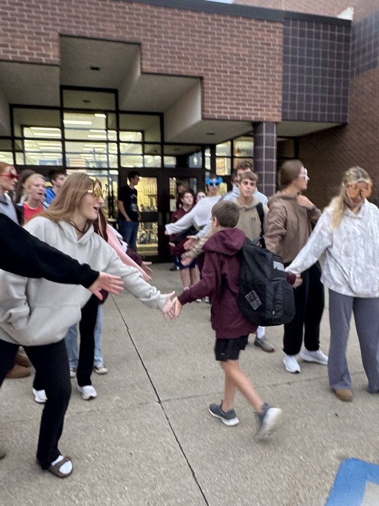 One Act students giving high fives to students arriving at school