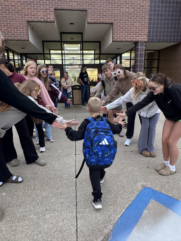 One Act students giving high fives to students arriving at school