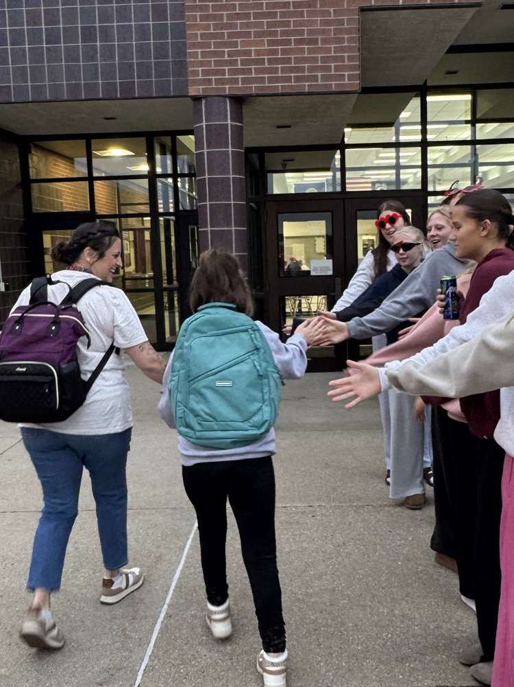 One Act students giving high fives to students arriving at school