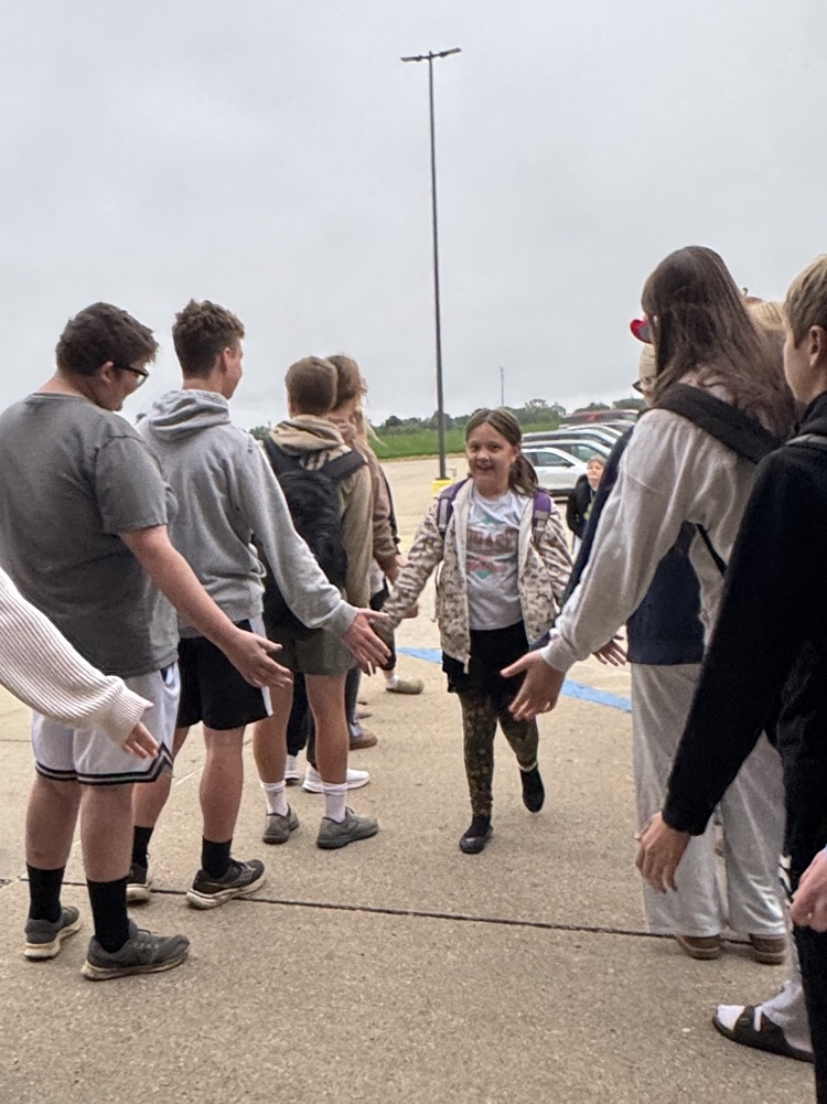 One Act students giving high fives to students arriving at school