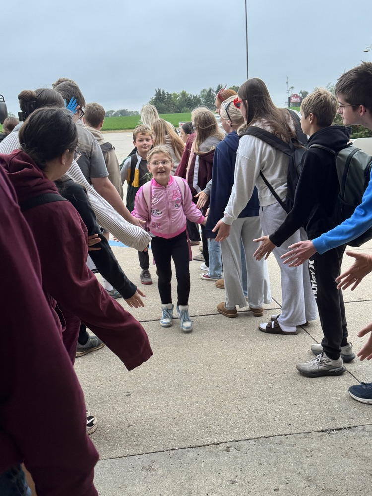 One Act students giving high fives to students arriving at school