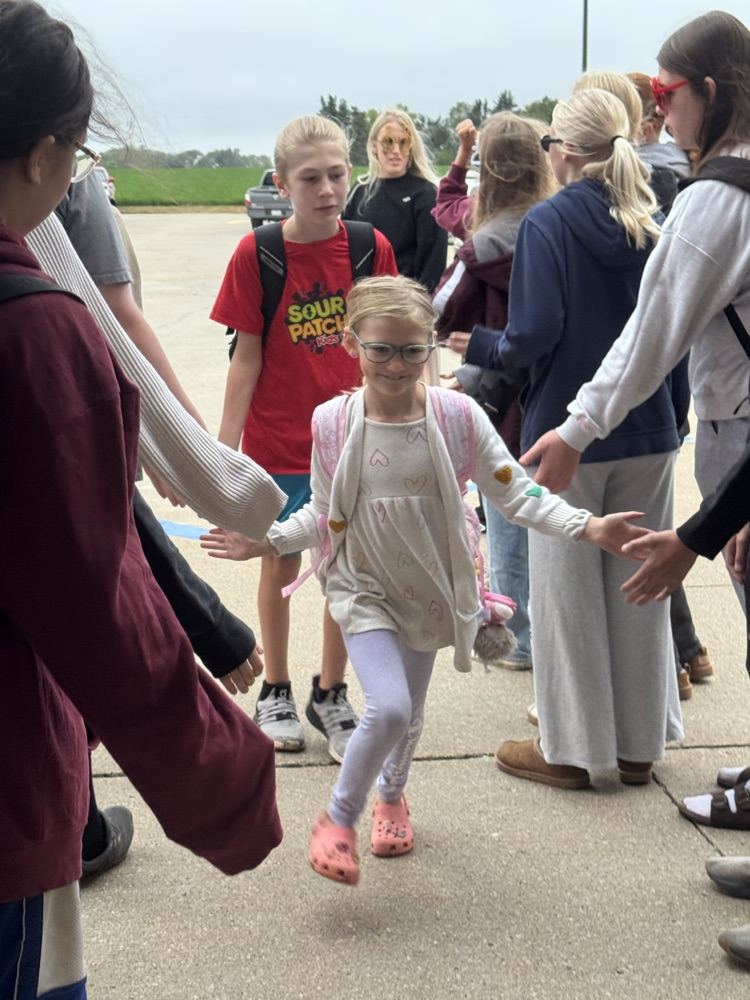 One Act students giving high fives to students arriving at school