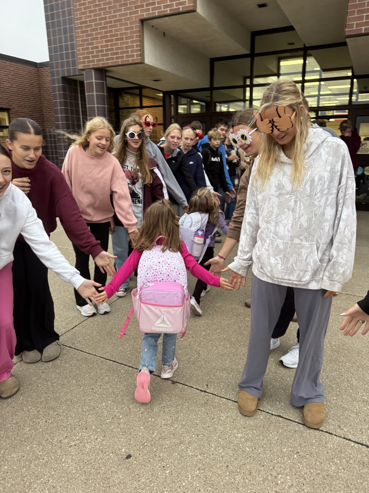 One Act students giving high fives to students arriving at school