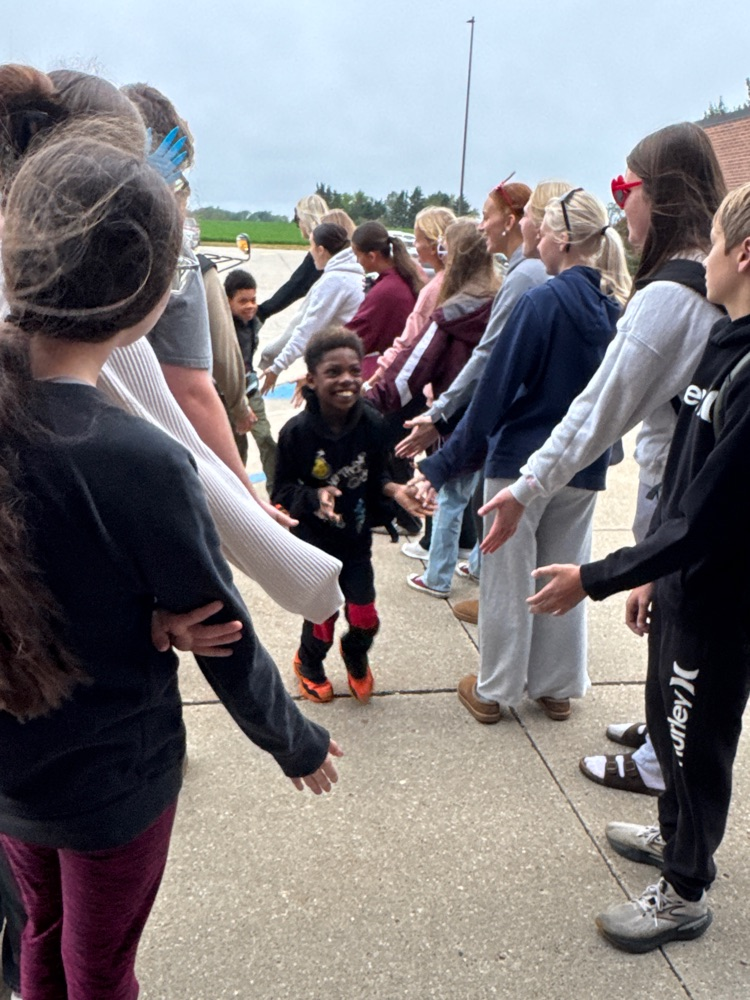 One Act students giving high fives to students arriving at school
