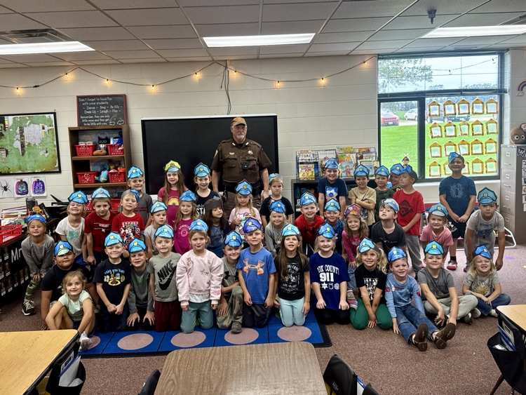 Kindergarten classes posing with Deputy Krepel