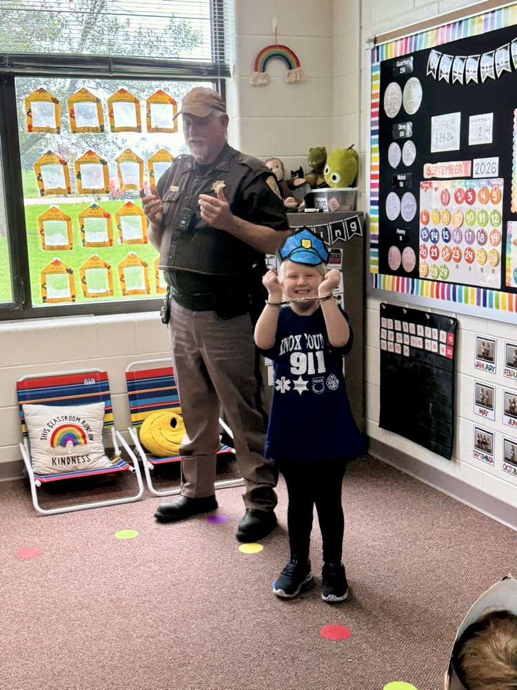 Deputy Krepel showing off the handcuffs and parts of his uniform