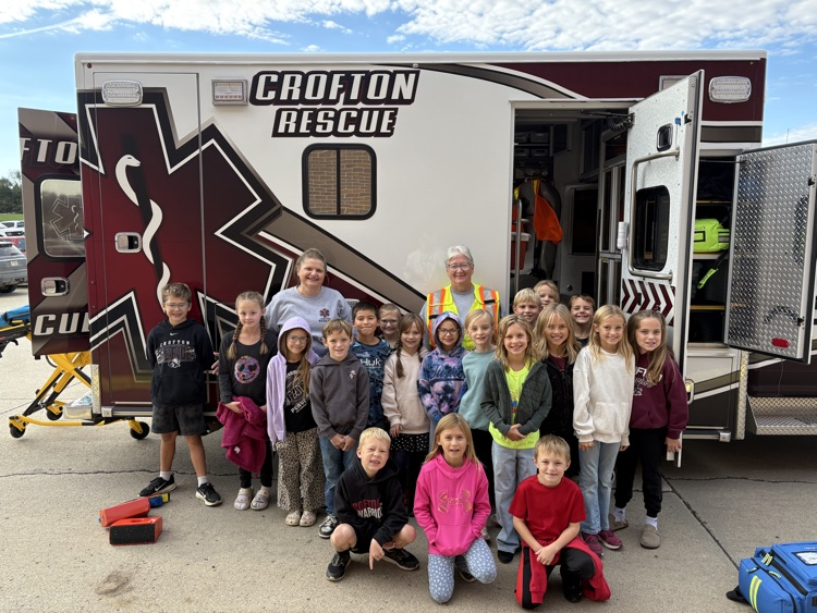 Students posing with members of the Crofton Fire Department and EMS