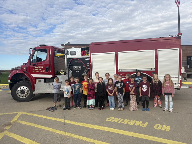 Students posing with members of the Crofton Fire Department and EMS