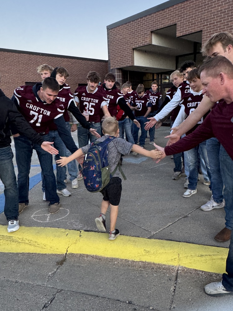 Crofton football team giving high fives to students