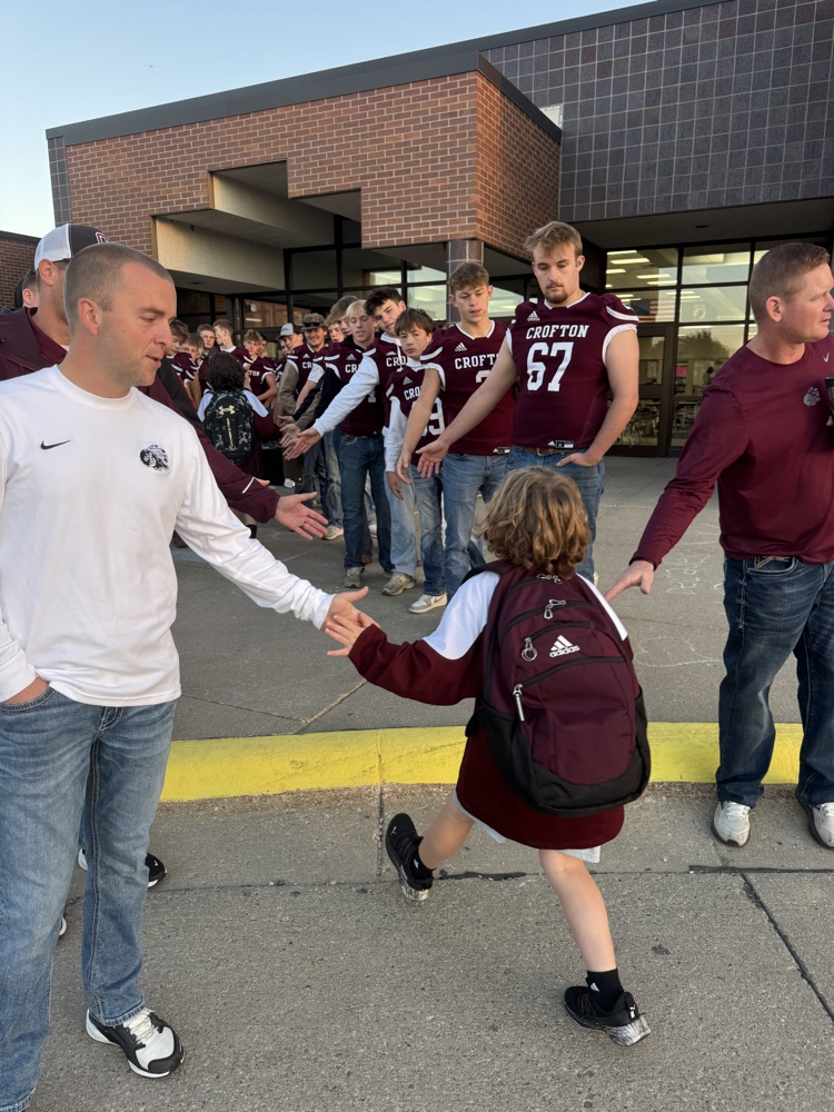 Crofton football team giving high fives to students