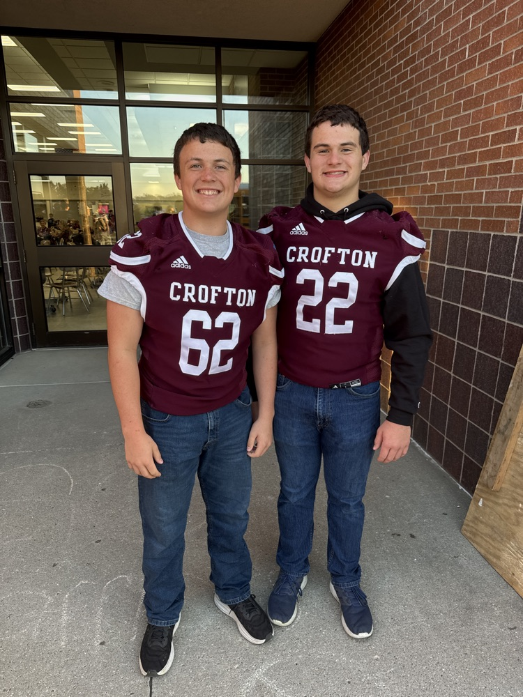 Siblings posing together for the football team High Five Friday