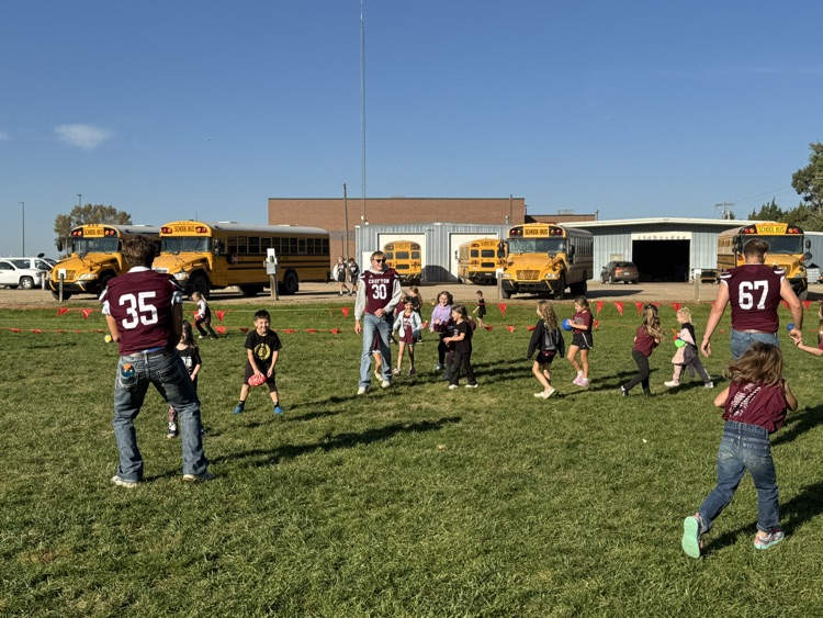 Kindergarteners and seniors together for Homecoming doing recess