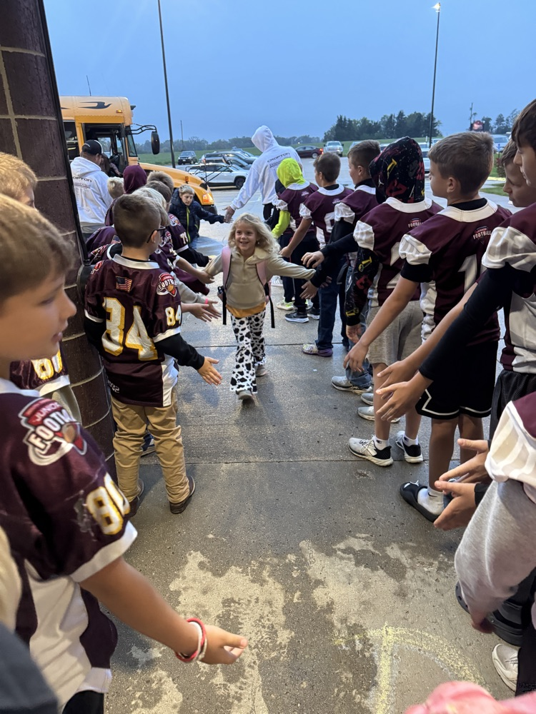 High Fives by the Youth Football Team to Crofton students