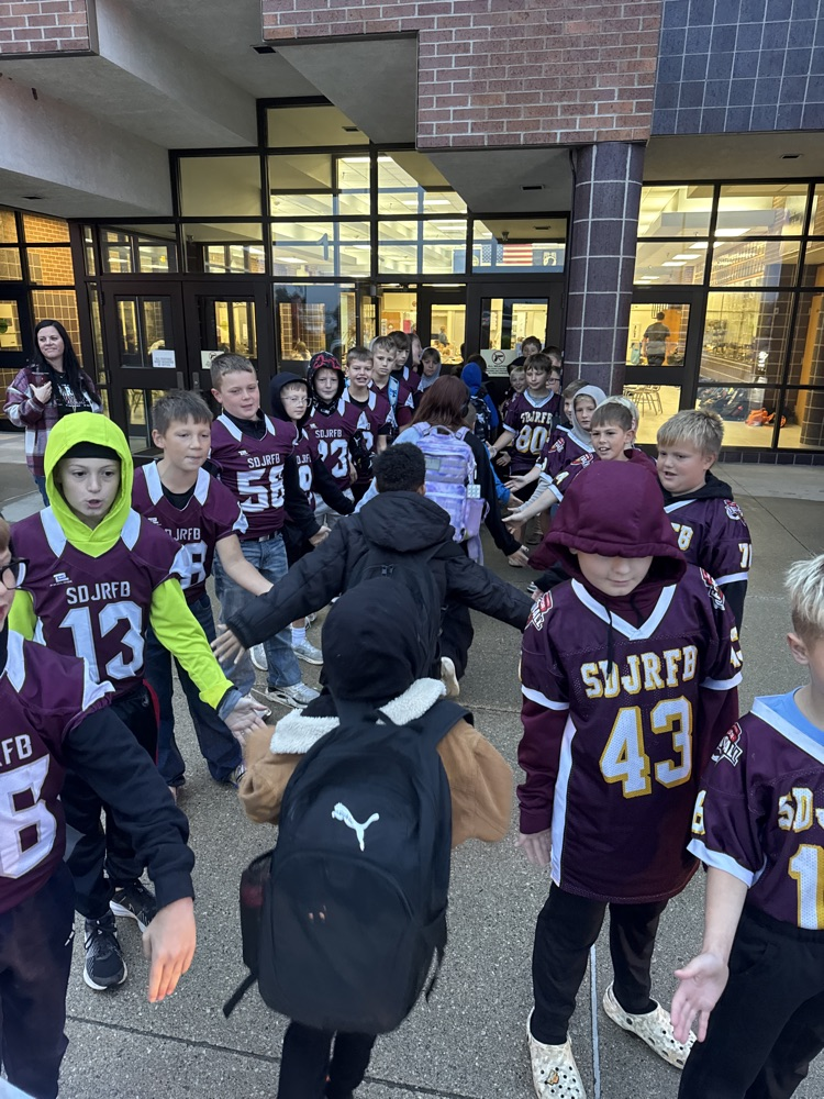 High Fives by the Youth Football Team to Crofton students