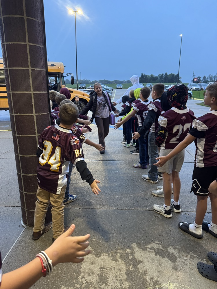 High Fives by the Youth Football Team to Crofton students