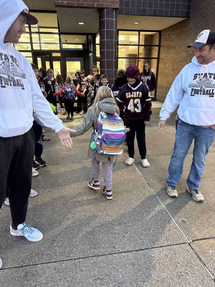 High Fives by the Youth Football Team to Crofton students