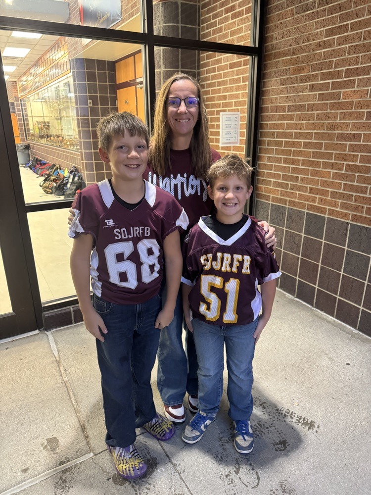 Family posing together for a photo during High Five Thursday 