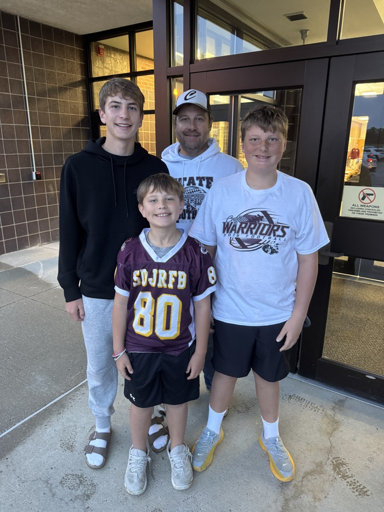 Family posing together for a photo during High Five Thursday