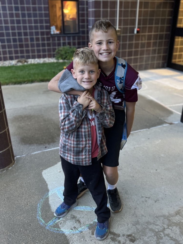 Family posing together for a photo during High Five Thursday