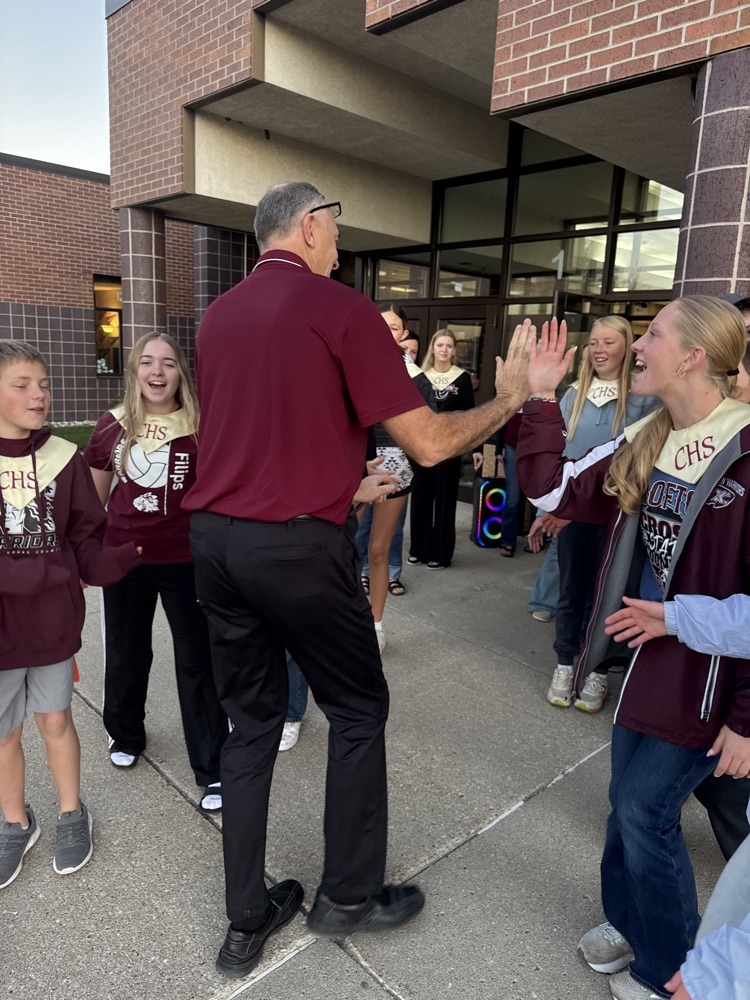 Crofton Chorus giving high fives to the superintendent