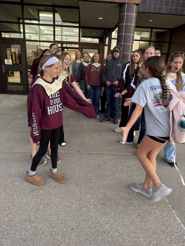 Crofton Chorus giving high fives to junior high students