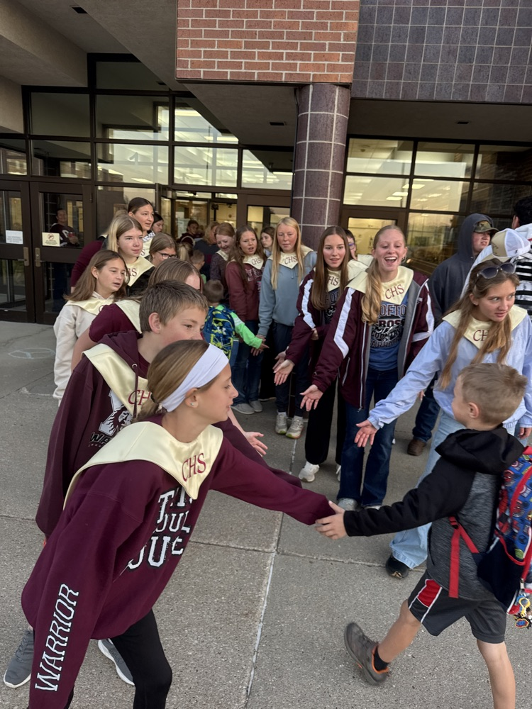Crofton Chorus members giving high fives to elementary students