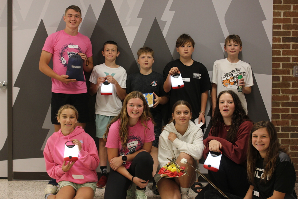 7th graders holding camping equipment