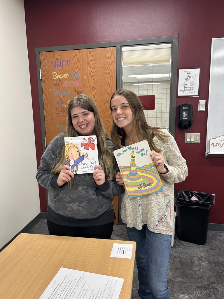two female students holding childhood books