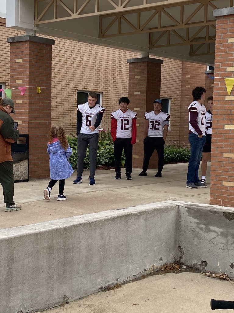 three football players greeting CRES students