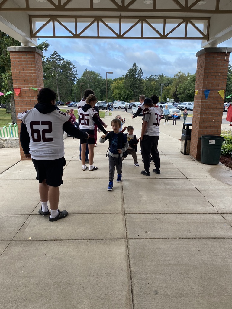 football players greeting CRES students