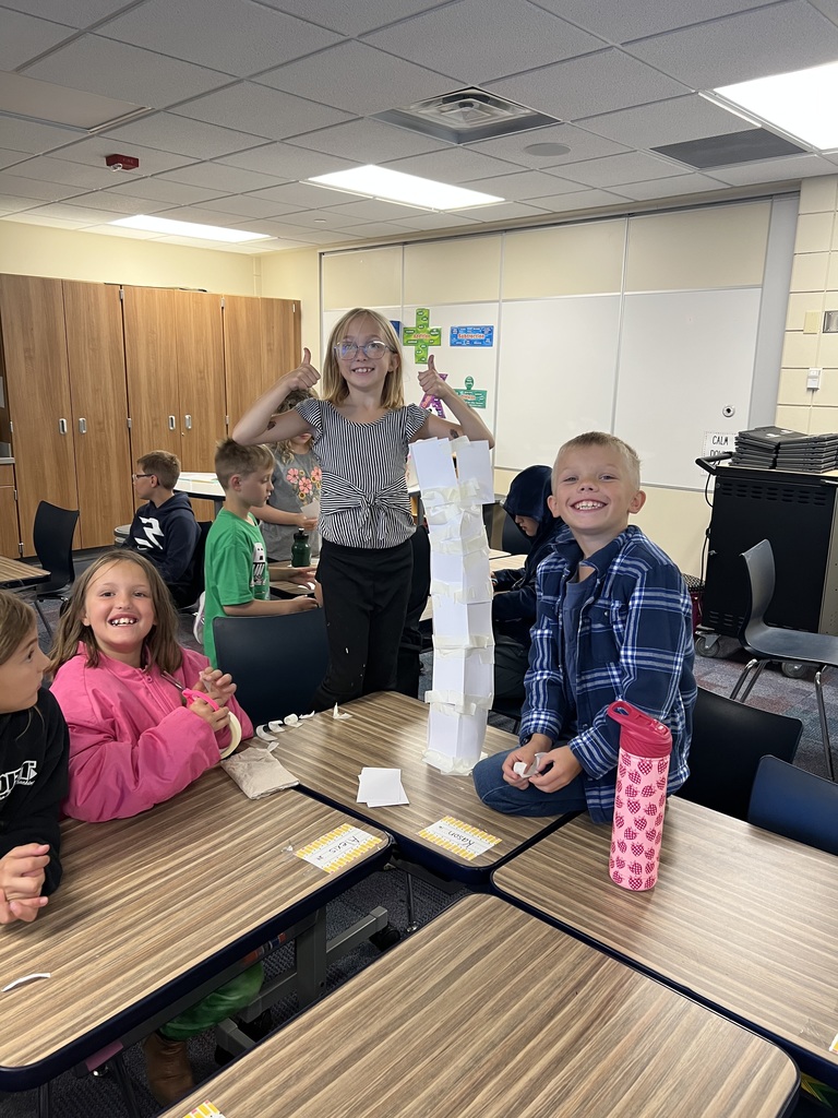 multiple students building with index cards