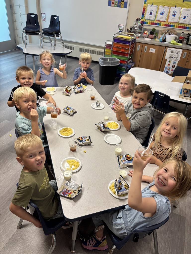 a table full of students having snack