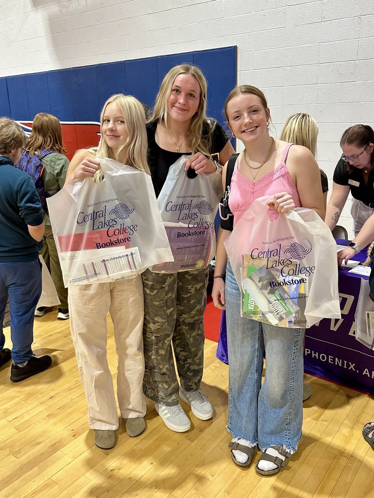 3 female seniors holding up their bags