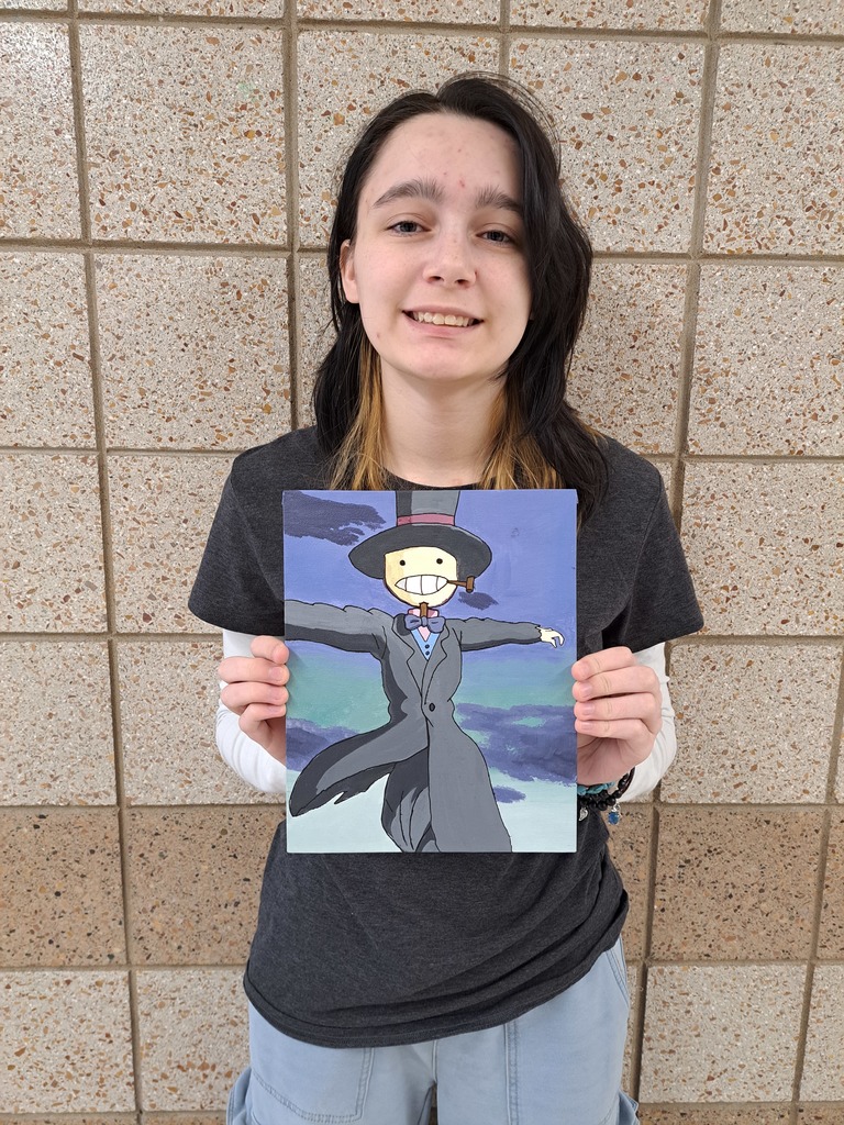 Female holding a painting from Howl's moving castle