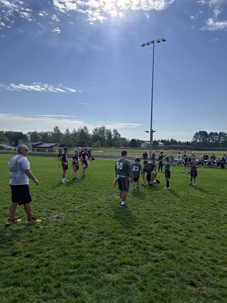 special olympics and unified partners lined up on the football field