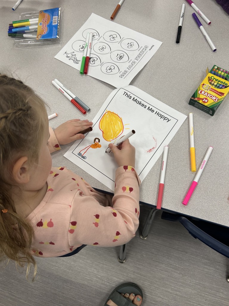 female young student drawing what makes her happy