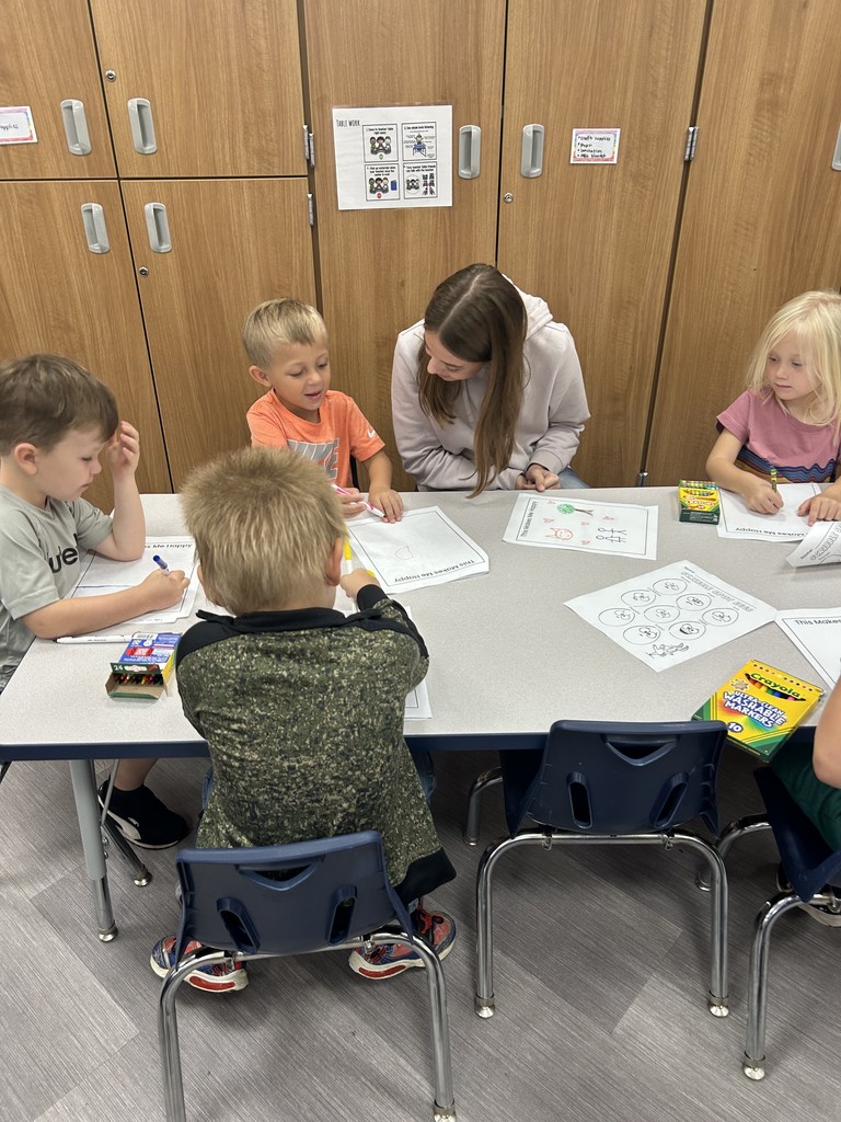 younger students working with a high school student