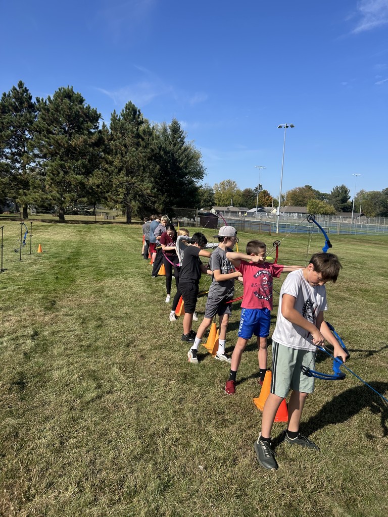 Junior high students performing archery
