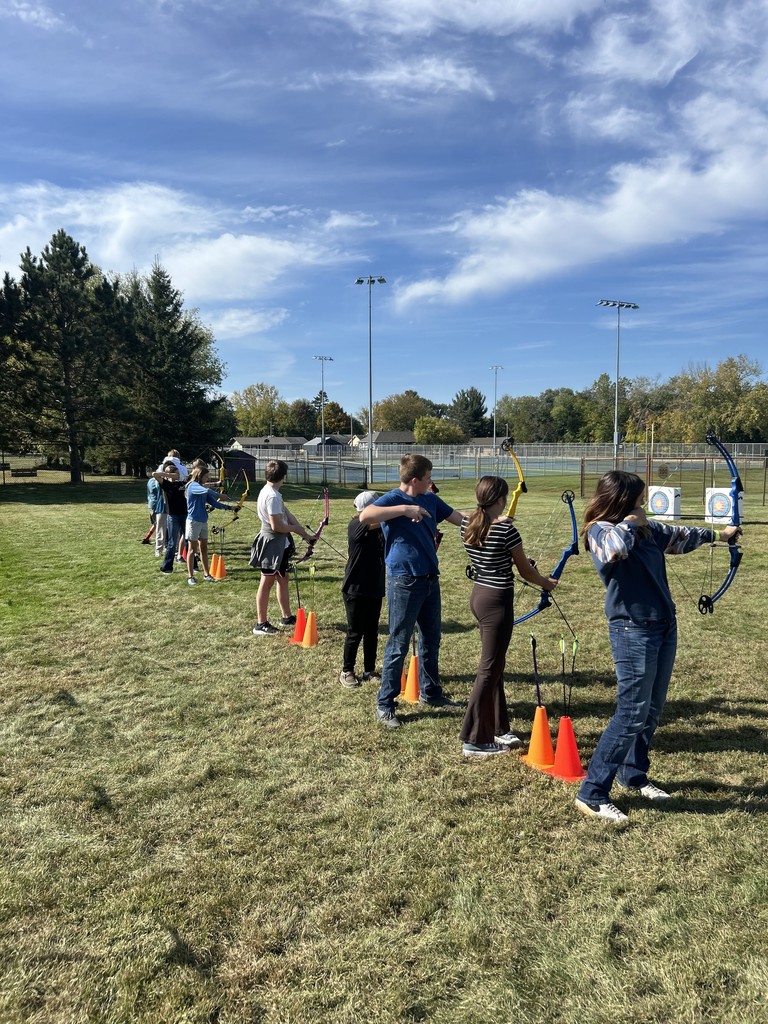 more junior high students performing archery